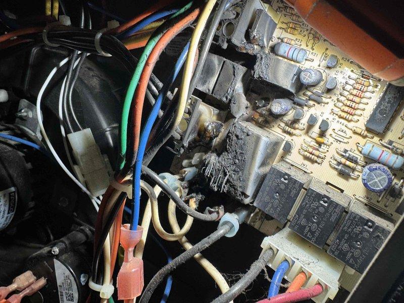 Responded to no heat call and performed diagnostic inspection of furnace control system. Upon examination of the control board assembly, discovered extensive mold growth and corrosion covering significant portions of the printed circuit board, particularly concentrated around electronic components in the upper section. The contamination had compromised multiple resistors, capacitors, and integrated circuits, rendering the board inoperable. Documented the damaged control board with photographs showing the severity of deterioration affecting the heating system's ability to function. Customer was informed that the circuit board requires replacement to restore heating operation.
