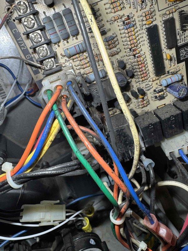 Responded to no heat call and performed diagnostic inspection of furnace control system. Upon examination of the control board assembly, discovered extensive mold growth and corrosion covering significant portions of the printed circuit board, particularly concentrated around electronic components in the upper section. The contamination had compromised multiple resistors, capacitors, and integrated circuits, rendering the board inoperable. Documented the damaged control board with photographs showing the severity of deterioration affecting the heating system's ability to function. Customer was informed that the circuit board requires replacement to restore heating operation.