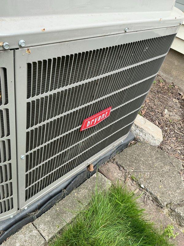 Completed annual preventative maintenance on a 6-year-old Bryant air conditioning system as part of the yearly maintenance program. Performed comprehensive AC tune-up including inspection of the outdoor condensing unit and indoor evaporator coil assembly. Inspected evaporator coil for proper operation and verified serpentine coil configuration showing normal wear patterns for unit age. Examined outdoor condenser unit positioned on concrete pad, confirmed Bryant unit operating within specifications with protective grille and fin coil system intact. Noted minor surface corrosion on exterior mounting hardware consistent with outdoor exposure. Verified system functionality and confirmed unit is operating properly with no issues identified requiring immediate attention.