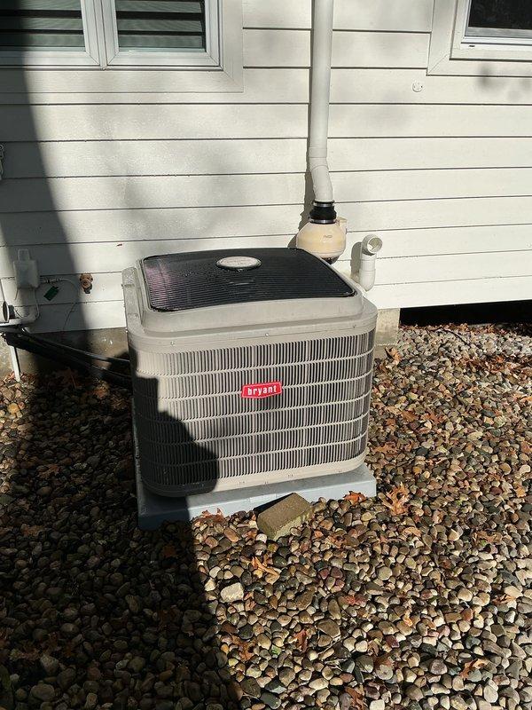 Completed annual cooling maintenance on Bryant outdoor condensing unit. Performed comprehensive system inspection, verified refrigerant lines and electrical disconnect in proper working condition, confirmed unit operational with no deficiencies noted. Equipment found clean and functioning normally on rock pad foundation with proper drainage.