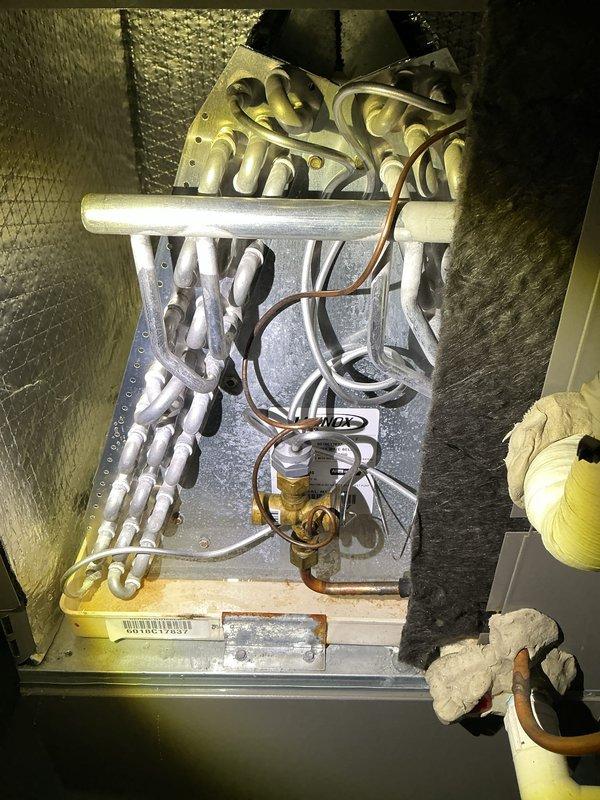 Completed annual cooling maintenance on residential HVAC system. Performed comprehensive inspection of furnace and air handler unit, examined evaporator coil assembly with A-frame configuration and verified proper copper refrigerant line connections. Documented system condition through photographic records showing all major components including ductwork, control devices, and coil assembly with reflective insulation. All equipment operational and ready for cooling season.