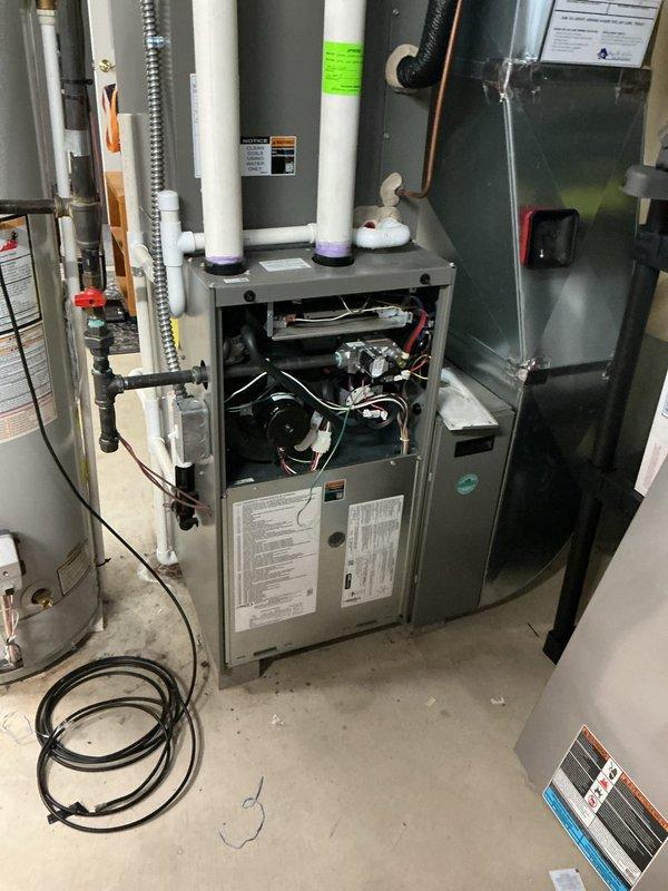 Responded to emergency service call for reported gas odor from 3-year-old furnace in basement that had been shut down for safety. Performed comprehensive leak detection inspection using electronic refrigerant/gas leak detector on furnace cabinet, heat exchanger, gas valve assembly, and all gas piping connections. Removed front access panel and thoroughly inspected internal components including blower motor, wiring harnesses, burner assembly, and flue piping. Checked all PVC vent pipe connections and condensate drain trap for proper seal integrity. Verified gas supply line connections and flexible conduit routing. All components inspected showed no evidence of gas leaks or combustion issues. Unit remains under parts and labor warranty coverage.
