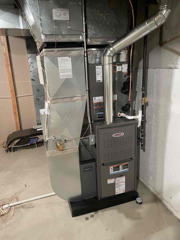 Completed full HVAC system installation in residential basement mechanical room. Installed 90,000 BTU high-efficiency Lennox furnace with humidifier and 2.5-ton air conditioning unit with rear discharge configuration. Connected all ductwork with properly insulated supply and return plenums, routed refrigerant lines, established gas supply connections, and completed electrical wiring to all components. Reconnected existing ductwork to new equipment, ensuring proper airflow distribution throughout home. Verified all mechanical permits were obtained prior to installation. System tested and operational upon completion with all safety controls functioning as designed.