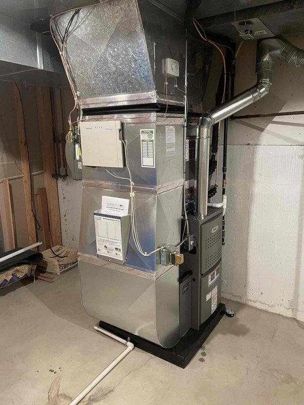Completed full HVAC system installation in residential basement mechanical room. Installed 90,000 BTU high-efficiency Lennox furnace with humidifier and 2.5-ton air conditioning unit with rear discharge configuration. Connected all ductwork with properly insulated supply and return plenums, routed refrigerant lines, established gas supply connections, and completed electrical wiring to all components. Reconnected existing ductwork to new equipment, ensuring proper airflow distribution throughout home. Verified all mechanical permits were obtained prior to installation. System tested and operational upon completion with all safety controls functioning as designed.