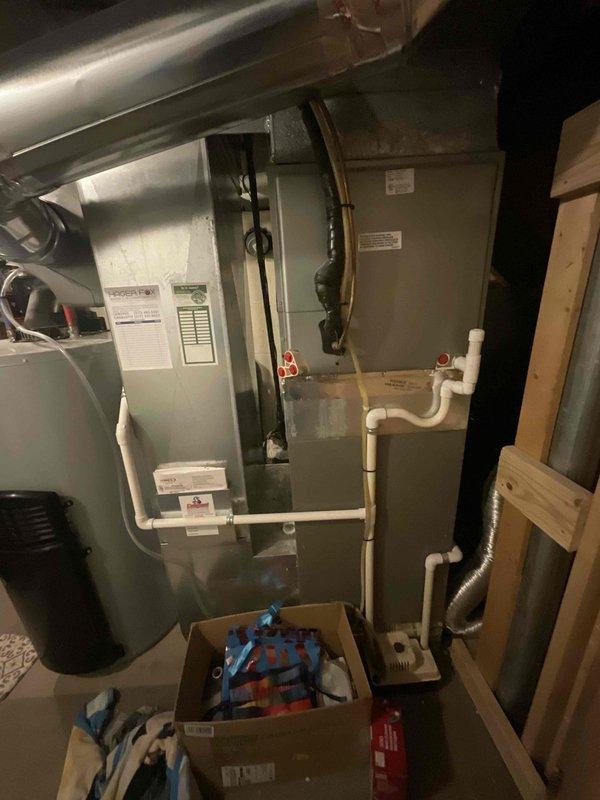 Conducted comprehensive site assessment for complete HVAC system replacement, evaluating existing 9-year-old furnace and 15-year-old air conditioning unit. Inspected indoor furnace installation in basement mechanical room, noting current green furnace with overhead air handler, PVC condensate drainage system, and metallic supply ductwork configuration. Evaluated outdoor condensing unit positioned on concrete pad alongside pool equipment, observing unit condition and clearance requirements. Documented existing system specifications, venting arrangements, gas line connections, electrical wiring, and ductwork transitions to provide accurate replacement equipment recommendations and installation requirements for expedited system changeout.