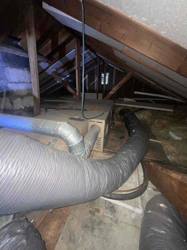 Provided estimate for complete HVAC system replacement including natural gas furnace and air conditioning unit for 25-year-old equipment located in attic space. Current air conditioning unit is non-operational while furnace remains functional. Assessed existing flexible ductwork configuration in attic and outdoor condenser unit placement on gravel pad adjacent to white vinyl siding, documented system layout and equipment access for proposed replacement installation.