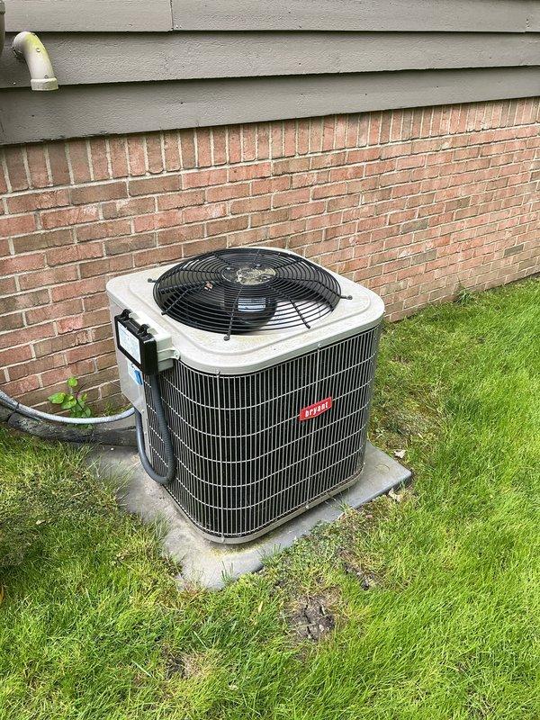 Completed annual cooling maintenance on Bryant residential air conditioning system. Performed comprehensive inspection of outdoor condenser unit, verified proper operation of top-mounted fan and protective grille, checked condenser coil fins for damage and airflow obstruction, and confirmed unit was level on concrete pad. Inspected refrigerant lines, drainage system including corrugated hose, and electrical connections. System operating within normal parameters with no immediate concerns identified.