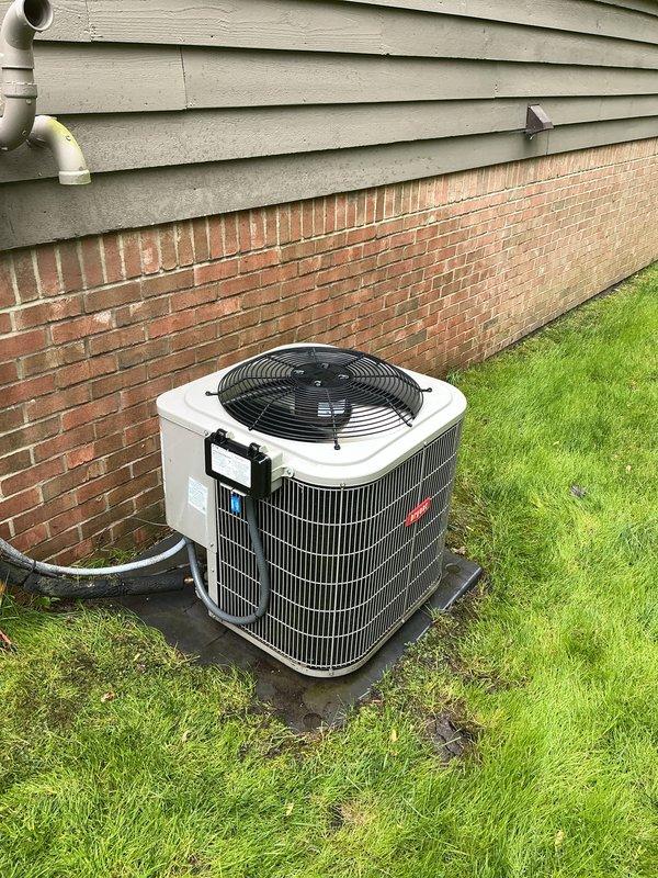 Completed annual cooling maintenance on Bryant residential air conditioning system. Performed comprehensive inspection of outdoor condenser unit, verified proper operation of top-mounted fan and protective grille, checked condenser coil fins for damage and airflow obstruction, and confirmed unit was level on concrete pad. Inspected refrigerant lines, drainage system including corrugated hose, and electrical connections. System operating within normal parameters with no immediate concerns identified.