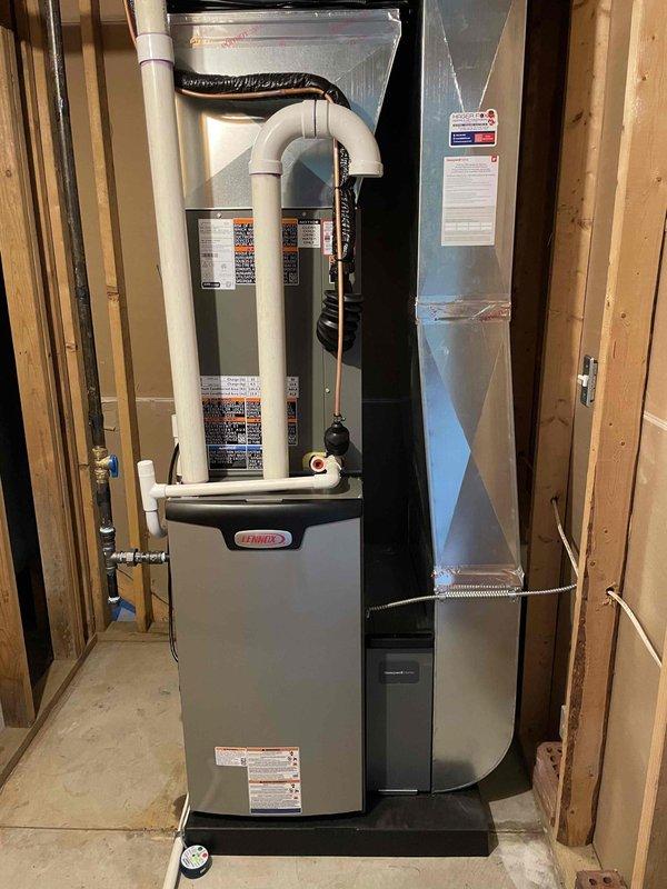Completed full HVAC system installation including a Lennox 70,000 BTU furnace with humidifier and 2.5-ton air conditioning unit with rear discharge configuration. Installed white PVC venting for furnace exhaust and intake, connected refrigerant lines between outdoor condenser and indoor air handler, and integrated all ductwork with proper insulation. Mounted and programmed Sensi digital thermostat on interior wall for system control, reconnected all electrical connections, and verified proper operation of heating and cooling functions upon startup.