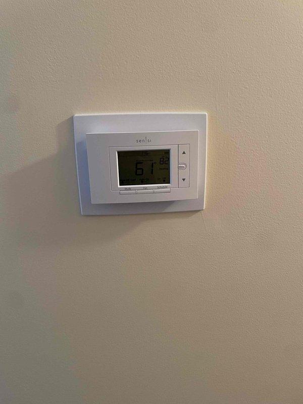 Completed full HVAC system installation including a Lennox 70,000 BTU furnace with humidifier and 2.5-ton air conditioning unit with rear discharge configuration. Installed white PVC venting for furnace exhaust and intake, connected refrigerant lines between outdoor condenser and indoor air handler, and integrated all ductwork with proper insulation. Mounted and programmed Sensi digital thermostat on interior wall for system control, reconnected all electrical connections, and verified proper operation of heating and cooling functions upon startup.