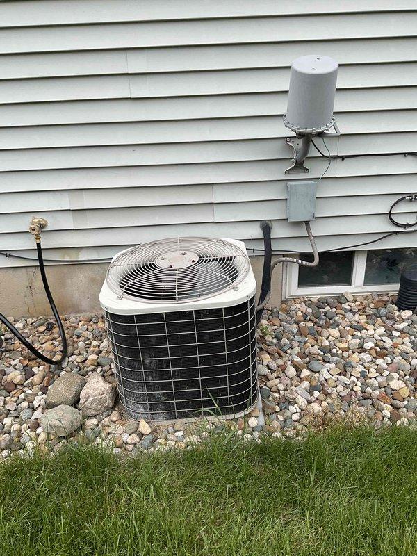 Completed comprehensive estimate for full HVAC system replacement at residential property with 23-year-old original equipment. Assessed existing furnace in basement utility area with metal ductwork and air handler configuration, along with outdoor cylindrical air conditioning unit mounted on river rock base against exterior wall with associated electrical connections and copper refrigerant lines. Customer requested expedited replacement timeline for both heating and cooling systems prior to summer season, with both units having reached end of expected service life.