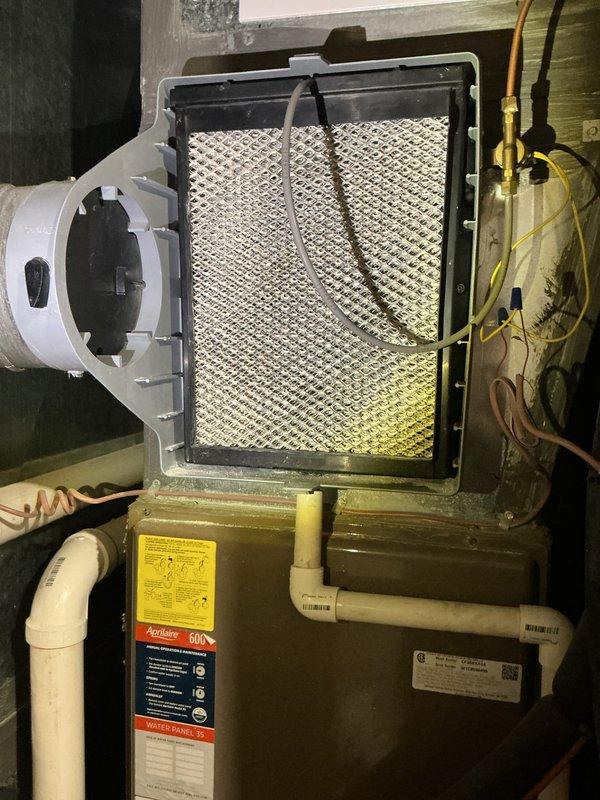 Completed annual cooling maintenance on residential HVAC system. Inspected furnace cabinet, verified air filter condition and proper installation, and examined Aprilaire humidifier attachment and associated components. Documented equipment model information and confirmed all accessible system components, including condensate drain lines and electrical connections, were functioning properly with no immediate service needs identified.