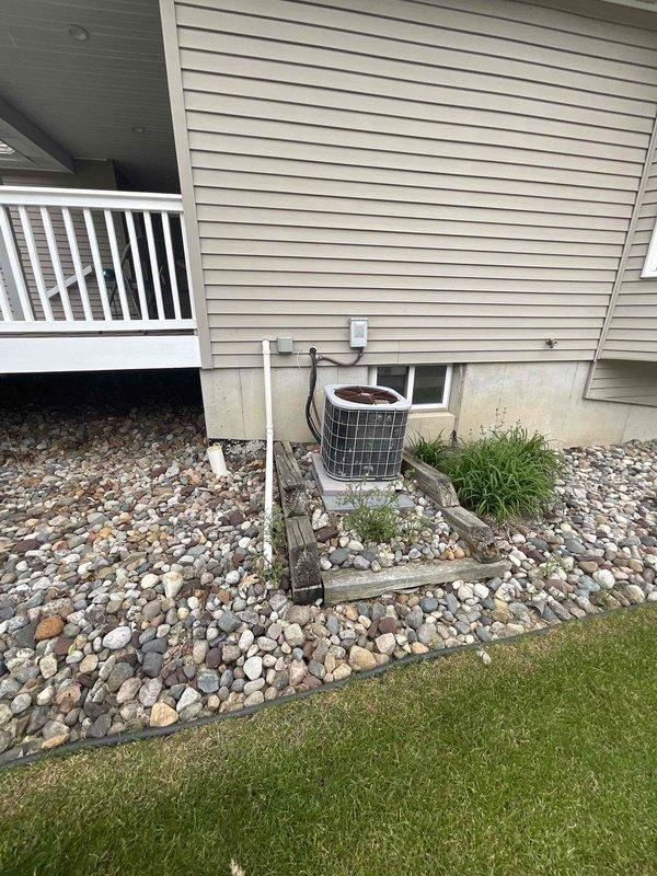 Conducted comprehensive assessment of existing residential HVAC system including basement-mounted furnace and exterior air conditioning condenser unit for replacement estimate. Evaluated current equipment configuration, ductwork layout, electrical connections, and installation conditions to determine specifications for new system installation. Documented equipment location, access points, and site-specific factors including outdoor condenser placement on concrete pad with rock landscaping and basement mechanical room layout with exposed framing to provide accurate replacement proposal.
