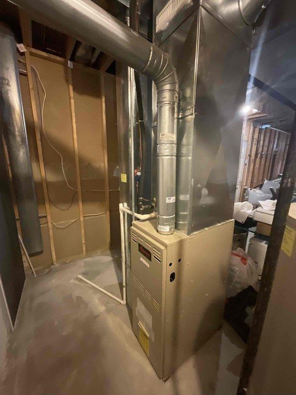 Conducted comprehensive assessment of existing residential HVAC system including basement-mounted furnace and exterior air conditioning condenser unit for replacement estimate. Evaluated current equipment configuration, ductwork layout, electrical connections, and installation conditions to determine specifications for new system installation. Documented equipment location, access points, and site-specific factors including outdoor condenser placement on concrete pad with rock landscaping and basement mechanical room layout with exposed framing to provide accurate replacement proposal.