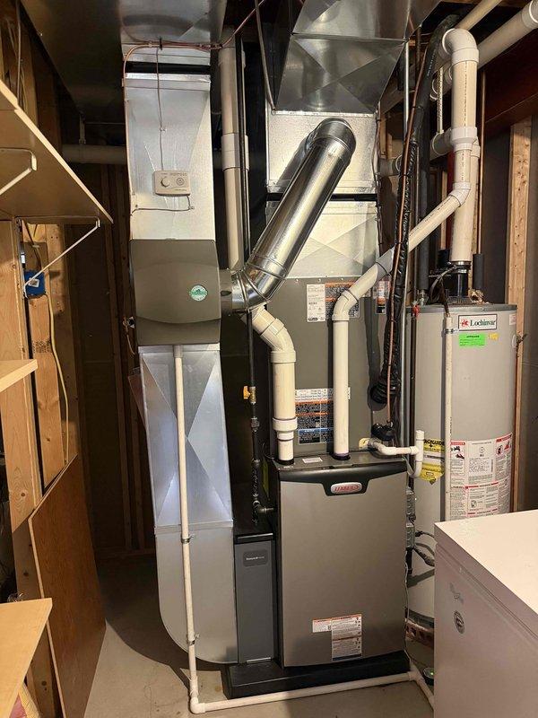 Completed full HVAC system installation including a 90,000 BTU high-efficiency furnace with humidifier and 3.5-ton air conditioning unit with rear discharge configuration. Installed white PVC venting for furnace exhaust and intake, ran electrical conduit and disconnect to outdoor condenser unit positioned on gravel pad, and reconnected all ductwork to existing system. All equipment installed per manufacturer specifications with proper clearances, permits obtained for mechanical work, and system tested for proper operation upon completion.