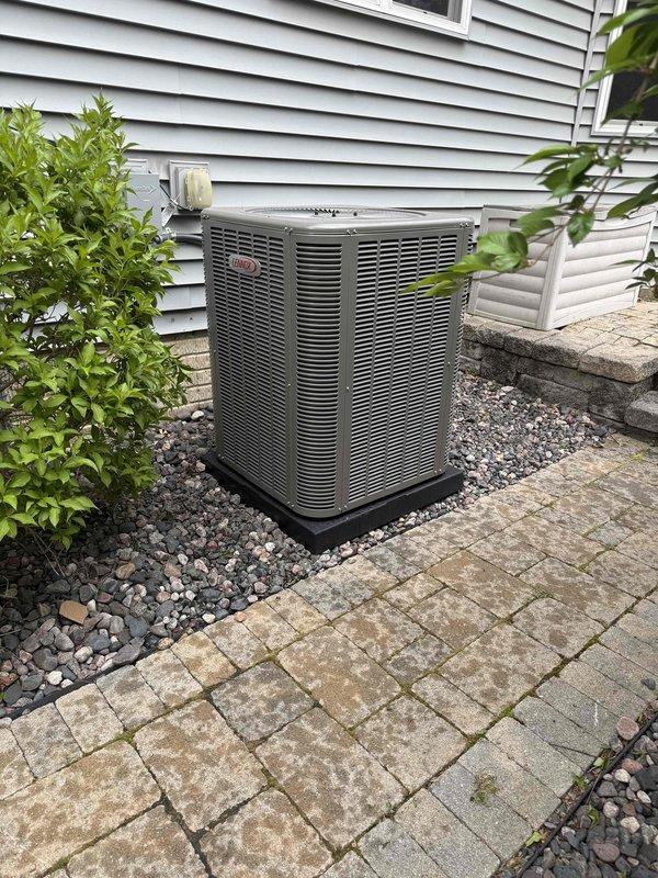 Completed full HVAC system installation including a 90,000 BTU high-efficiency furnace with humidifier and 3.5-ton air conditioning unit with rear discharge configuration. Installed white PVC venting for furnace exhaust and intake, ran electrical conduit and disconnect to outdoor condenser unit positioned on gravel pad, and reconnected all ductwork to existing system. All equipment installed per manufacturer specifications with proper clearances, permits obtained for mechanical work, and system tested for proper operation upon completion.