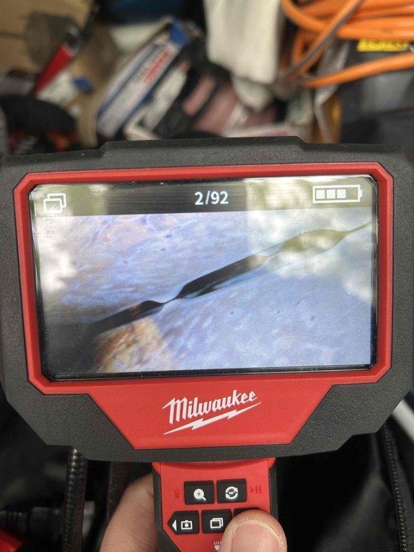 Responded to no heat call on 40-year-old furnace with suspected thermocouple failure. Upon arrival, performed visual inspection and utilized Milwaukee digital inspection camera to examine heat exchanger and burner assembly interior conditions. Camera inspection revealed significant deterioration and potential safety concerns typical of equipment at end of service life. Diagnosed failed thermocouple preventing pilot flame detection and main burner ignition. Due to age of unit and observed internal conditions during camera inspection, advised customer of equipment status and recommended replacement over repair given safety considerations and availability of parts for 40-year-old system.