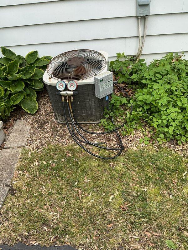 Completed annual cooling maintenance on residential air conditioning system. Connected manifold gauges to outdoor condenser unit and verified refrigerant pressures within manufacturer specifications. Inspected condenser coil condition, fan motor operation, and electrical connections at disconnect box. Unit operating properly with no deficiencies noted at time of service.
