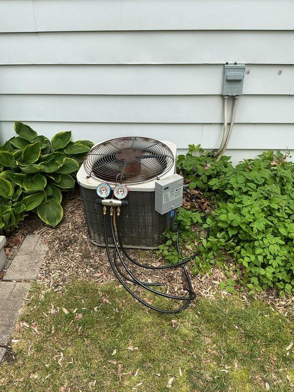 Completed annual cooling maintenance on residential air conditioning system. Connected manifold gauges to outdoor condenser unit and verified refrigerant pressures within manufacturer specifications. Inspected condenser coil condition, fan motor operation, and electrical connections at disconnect box. Unit operating properly with no deficiencies noted at time of service.
