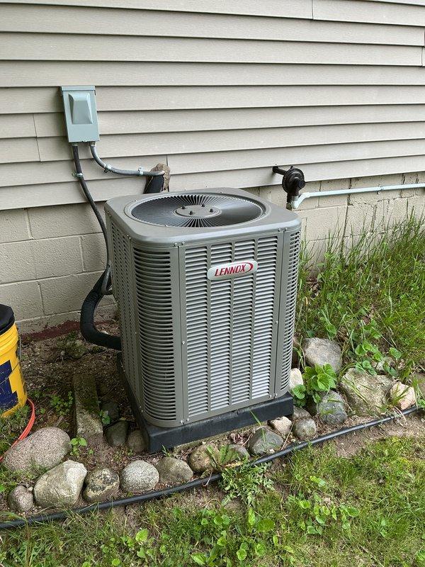 Completed annual cooling maintenance on Lennox model 13ACXN030-230-24 air conditioning system. Performed comprehensive tune-up including inspection of outdoor condenser unit, verified refrigerant charge of HFC-410A at factory specification of 5 lbs 2 oz, checked electrical connections and components, inspected compressor operation, and confirmed all system parameters within manufacturer specifications. Unit operating normally with no issues found. Documented equipment specifications and current condition with photos for service records.
