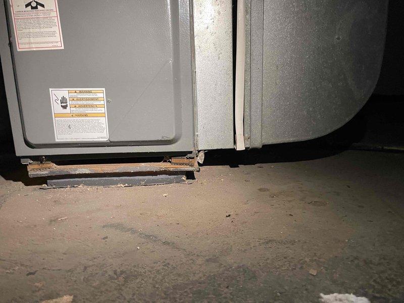 Conducted HVAC estimate for replacement of existing 2004 natural gas furnace located in basement. Current furnace operational but nearing end of service life, with visible corrosion on equipment base and support structure. Assessed installation requirements, existing ductwork configuration, and clearances for new equipment replacement, documenting current system conditions with photographs for quote preparation.