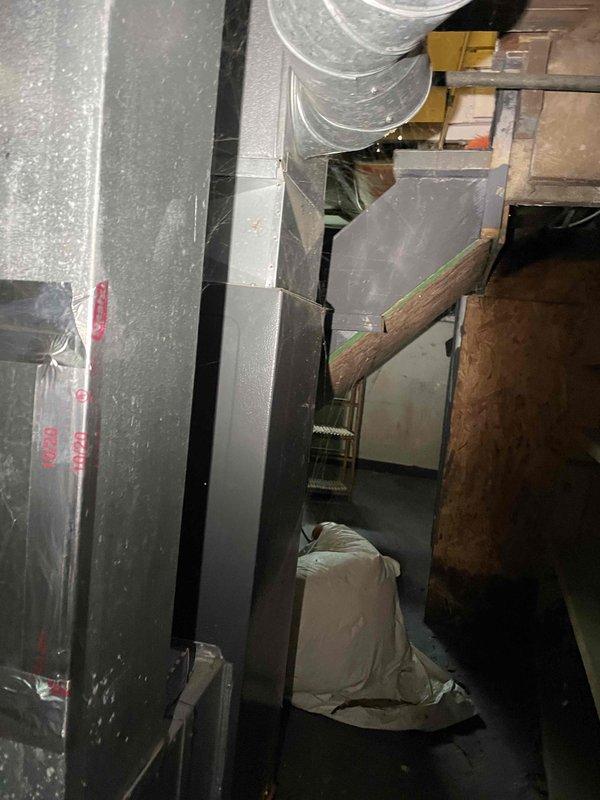 Conducted HVAC estimate for replacement of existing 2004 natural gas furnace located in basement. Current furnace operational but nearing end of service life, with visible corrosion on equipment base and support structure. Assessed installation requirements, existing ductwork configuration, and clearances for new equipment replacement, documenting current system conditions with photographs for quote preparation.