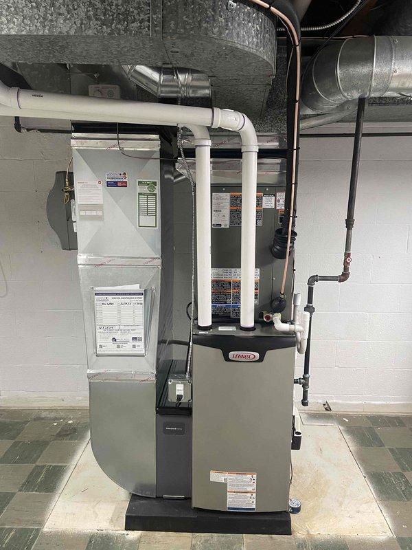 Completed full HVAC system installation including a 70,000 BTU furnace with humidifier and 2.5-ton air conditioning unit with rear discharge configuration. Installed new electrical circuit to support the system, ran all necessary ductwork, venting, and condensate drainage lines using white PVC piping, and connected copper refrigerant lines between indoor and outdoor components. Mechanical and electrical permits were obtained prior to installation, and all work was performed to code specifications with proper clearances and professional routing of all utilities in the basement mechanical room.