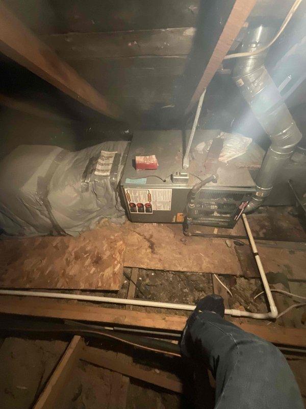 Provided comprehensive estimate for complete air conditioning system replacement in attic location accessible by built-in ladder. Existing non-functional unit exhibited significant age-related deterioration, including visible rust on metal components, corroded ductwork connections, and accumulated debris throughout the mechanical space. Assessment documented compromised equipment housing, dusty flexible ductwork with surface deterioration, and outdated air handler requiring full system upgrade to restore cooling capacity and ensure reliable operation.