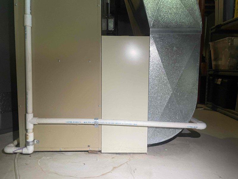 Completed estimate for replacement of 30-year-old Amana furnace system located in basement utility area. Inspected existing heating equipment, ductwork configuration, and associated components including PVC condensate drain lines and electrical connections. Documented current system specifications and installation layout to provide comprehensive replacement options for aging HVAC equipment that has reached end of expected service life.