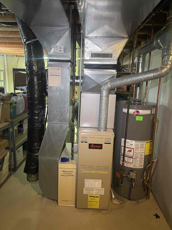 Completed estimate for replacement of 30-year-old Amana furnace system located in basement utility area. Inspected existing heating equipment, ductwork configuration, and associated components including PVC condensate drain lines and electrical connections. Documented current system specifications and installation layout to provide comprehensive replacement options for aging HVAC equipment that has reached end of expected service life.
