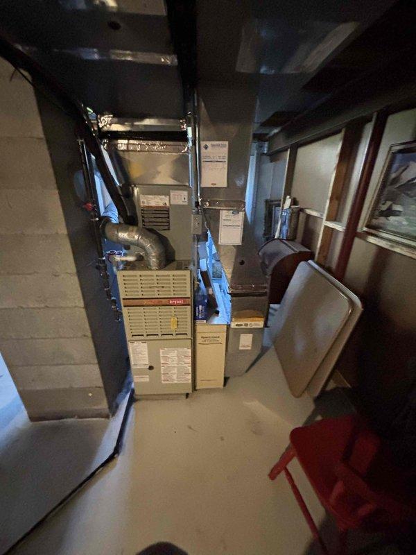 Provided estimate for furnace replacement in basement mechanical room where existing unit is non-operational and has reached end of service life. Assessed confined space installation with existing ductwork, evaluated electrical and gas connections, and documented current equipment configuration including adjacent water heater and plumbing systems to determine proper replacement specifications and clearance requirements.