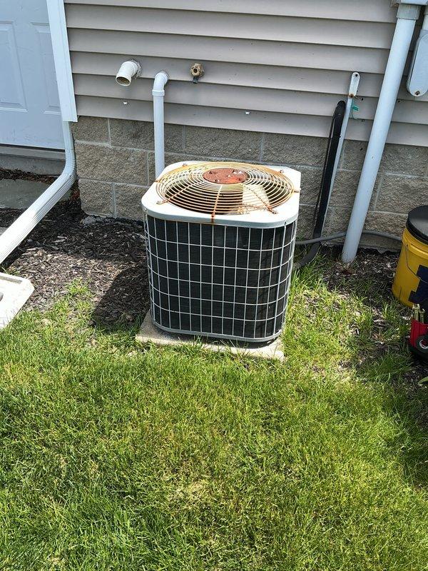 Completed spring AC tune-up on 16-year-old residential air conditioning system. Performed comprehensive maintenance including inspection of outdoor condensing unit, verification of electrical connections at disconnect and meter, assessment of refrigerant lines and PVC condensate drainage, and confirmation of proper fan operation. System operating within normal parameters at time of service; noted moderate rust and corrosion present on condenser top panel consistent with unit age and outdoor exposure.
