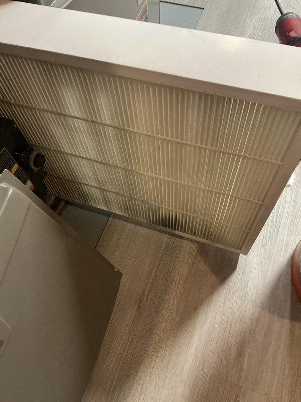 Completed annual cooling maintenance inspection on HVAC system. Identified and replaced heavily soiled air filter showing significant dust and debris accumulation throughout mesh material, along with evaporator coil pad replacement. System access panels secured and unit returned to normal operation with improved airflow efficiency.