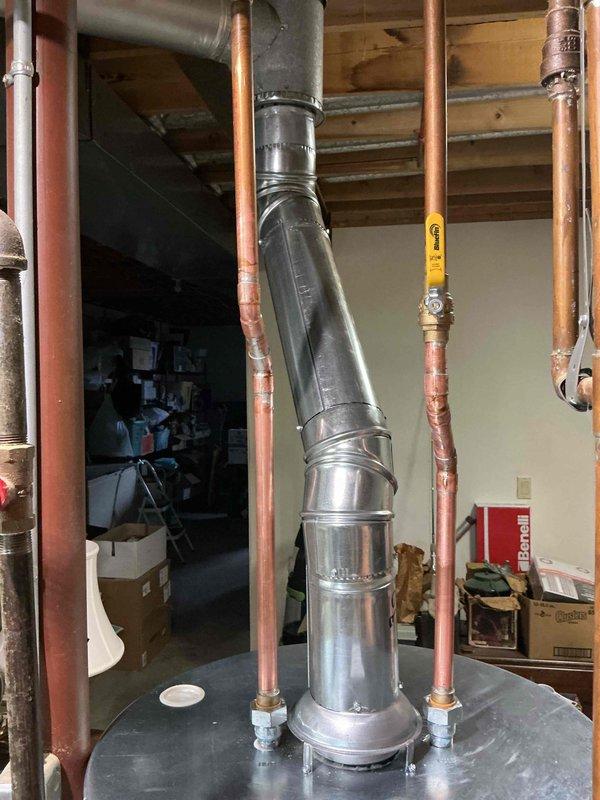 Completed installation of 50-gallon tanked water heater in basement utility area. Removed existing unit and installed new water heater with proper venting through existing ductwork system. Connected copper supply and discharge lines with code-compliant shutoff valves and fittings, ensuring all connections were secure and leak-free. System tested and verified operational.