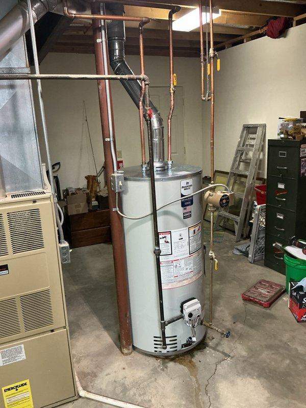 Completed installation of 50-gallon tanked water heater in basement utility area. Removed existing unit and installed new water heater with proper venting through existing ductwork system. Connected copper supply and discharge lines with code-compliant shutoff valves and fittings, ensuring all connections were secure and leak-free. System tested and verified operational.