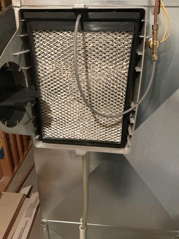 Completed annual cooling maintenance inspection on HVAC system. Evaluated and documented condition of existing Flanders VP-MERV 8 air filter showing dust accumulation and discoloration, indicating normal usage. Inspected humidifier assembly including evaporator pad with honeycomb media and associated water supply connections, confirming proper installation and operation of all system components.