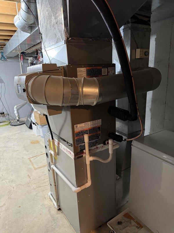 Completed full installation of 3-ton Lennox air conditioning condenser unit and evaporator coil system in residential property. Outdoor condenser positioned on pad in backyard with proper clearance for airflow, connected to indoor evaporator coil mounted on existing furnace in basement utility area. Installed refrigerant line set connecting outdoor and indoor components, completed all electrical connections for right-side configuration, and reconnected system per mechanical permit specifications. System tested and verified operational upon completion.