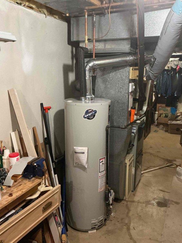 Successfully installed a 50-gallon tall skinny water heater in basement mechanical room. Completed all plumbing connections including hot and cold water lines with proper insulation, installed gas line with shut-off valve, and configured venting system with metallic vent pipe routed to existing ceiling penetration. All connections tested and verified operational with no leaks detected.