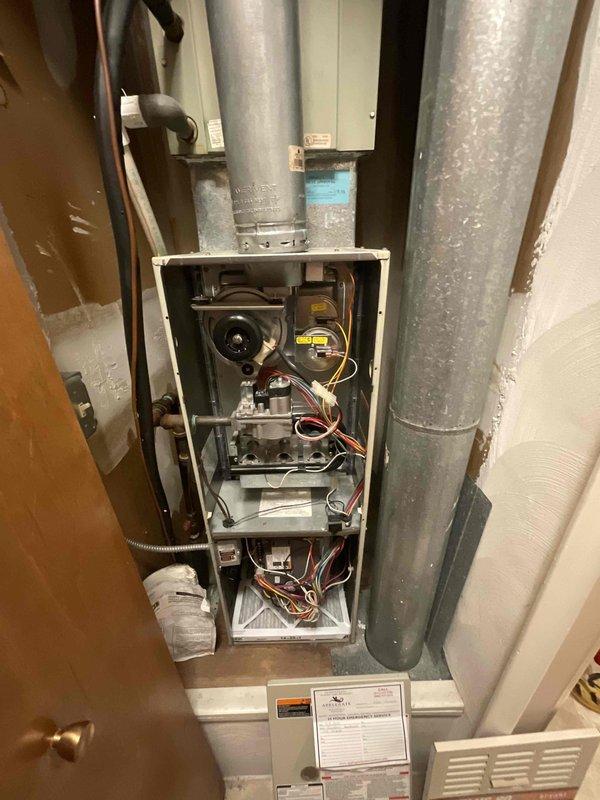 Provided comprehensive estimate for complete HVAC system replacement including furnace and air conditioning unit located in kitchen utility closet. Existing 30-year-old air conditioning system remains operational but has exceeded service life expectancy, while furnace age requires verification. Evaluated confined installation space containing aged ductwork, assessed existing vertical supply and return plenum connections showing significant weathering, and documented current equipment configuration including blower assembly and control components for proper replacement sizing and specifications.