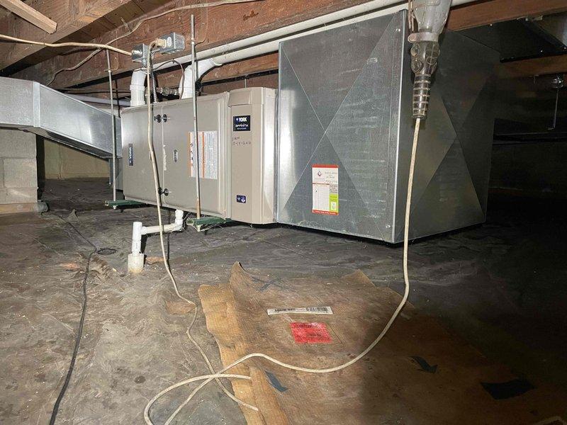 Completed comprehensive estimate for full HVAC system replacement including 14-year-old furnace and new air conditioning installation for whole house that previously had no AC. Assessed attic installation area containing existing air handler unit and ductwork system with exposed beams, evaluated PVC condensate drainage lines, electrical conduit routing, and structural clearances for new equipment placement. Inspected exterior location for outdoor condensing unit installation adjacent to vinyl siding foundation area, confirming adequate clearance, proper drainage conditions, and accessibility for refrigerant line set routing between indoor and outdoor components.