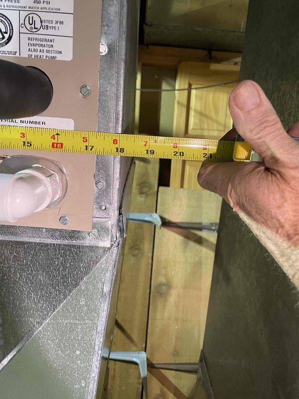 Conducted comprehensive assessment of 20-year-old basement HVAC system to provide replacement estimate for generator, air conditioning unit, and evaporator coil. Inspected existing air handler installation, ductwork configuration, and refrigerant evaporator components. Documented current equipment dimensions and clearances using precision measurements to ensure proper sizing for replacement units. Photographed existing system layout including vertical air handler positioning, metallic ductwork routing, and spatial constraints within unfinished basement utility area. Evaluated operational status of functioning equipment and verified manufacturer specifications on existing evaporator coil rated at 450 PSI. Assessed installation requirements for new generator integration with current HVAC infrastructure and determined necessary modifications for seamless system replacement.