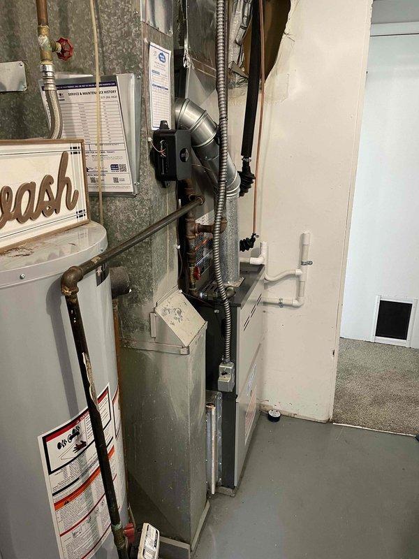 Completed installation of 2-ton air conditioning system with matching evaporator coil in rear yard location. Connected refrigerant lines, electrical wiring, and condensate drain to existing furnace and air handler in basement mechanical room. System tested and verified operational with proper airflow and refrigerant charge.