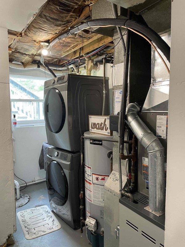 Completed installation of 2-ton air conditioning system with matching evaporator coil in rear yard location. Connected refrigerant lines, electrical wiring, and condensate drain to existing furnace and air handler in basement mechanical room. System tested and verified operational with proper airflow and refrigerant charge.
