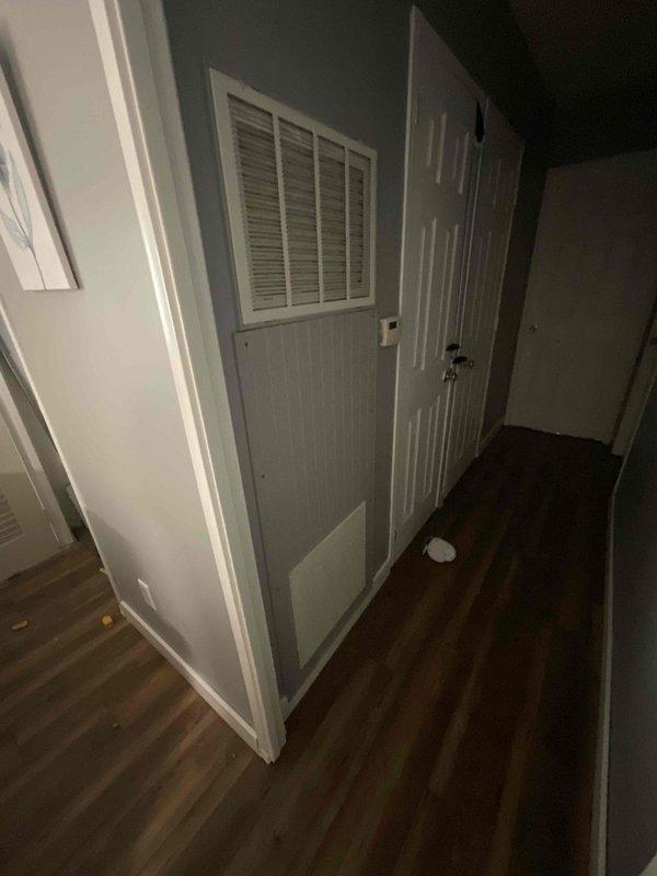 Completed estimate for full HVAC system replacement at residential property. Assessed existing furnace of unknown age located in confined mechanical space with tight clearance and evaluated property currently lacking air conditioning system. Documented equipment condition showing significant age-related wear, dust accumulation, and aging metal cabinet housing. Evaluated installation space constraints including narrow hallway access with louvered ventilation door and limited attic or mechanical closet clearance for future equipment replacement. Provided replacement options for complete heating and cooling system installation to address immediate need for air conditioning addition and aging furnace replacement.