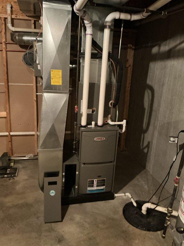 Completed annual cooling maintenance on residential HVAC system. Inspected Lennox furnace unit, air handler components, and associated ductwork in basement mechanical room. Examined evaporator coil assembly with mesh filter, verified proper refrigerant line connections, checked condensate drainage system including PVC piping and sump pump operation, and confirmed all electrical connections and controls were functioning properly. System operating within normal parameters with no deficiencies noted.