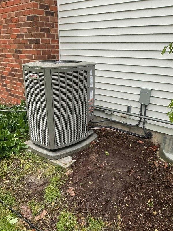 Completed full HVAC system replacement including installation of 110,000 BTU gas furnace and 4-ton air conditioning unit. Furnace installed in basement utility area with proper venting and electrical connections, positioned adjacent to existing water heater. Outdoor Lennox condenser unit mounted on concrete pad in corner location between brick and vinyl siding exterior walls, with refrigerant lines and electrical conduit routed to junction box. All mechanical connections completed per manufacturer specifications and local code requirements, with permits obtained prior to installation.