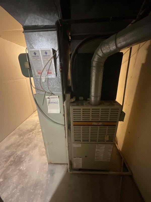 Conducted on-site evaluation for air conditioning system replacement. Existing Bryant AC unit estimated at over 10 years old with customer planning replacement within approximately six weeks. Inspected basement-installed HVAC equipment including furnace with connected ductwork and evaporator coil assembly. Documented current system configuration with photos showing equipment layout, ductwork routing, and utility room access conditions. Provided replacement options and discussed available promotional offers per customer inquiry.
