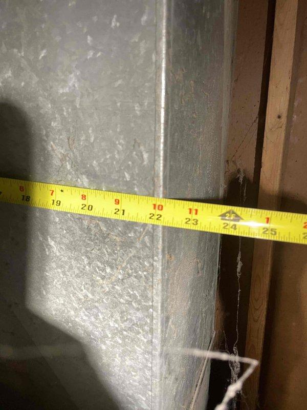 Conducted on-site estimate for central air conditioning installation at single-family ranch home with existing forced-air heating system and ductwork infrastructure. Performed detailed assessment of existing duct system, measuring trunk line dimensions and evaluating current ductwork condition to determine compatibility with proposed AC system. Documented duct sizing and configuration, noting existing metal ductwork appears adequate for AC integration, and provided customer with equipment options and installation specifications for complete central cooling system addition.