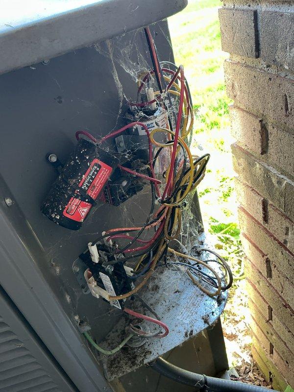 Responded to no cooling complaint on 10-year-old air conditioning system that had been blowing room temperature air since recent maintenance visit. Upon arrival, performed diagnostic testing of outdoor unit electrical components including capacitor and contactor within exterior control panel. Multimeter testing revealed capacitor failure with reading of 35.25 MFD, significantly below manufacturer specifications required for proper compressor operation. Electrical panel showed normal age-related accumulation of debris and environmental exposure but connections remained intact. Replaced failed capacitor, verified proper voltage and amperage readings across all electrical components, and confirmed contactor operation. Cycled system through complete operational test, verified proper compressor startup, and confirmed cold air delivery throughout home. System restored to normal cooling operation with appropriate temperature differential between supply and return air.
