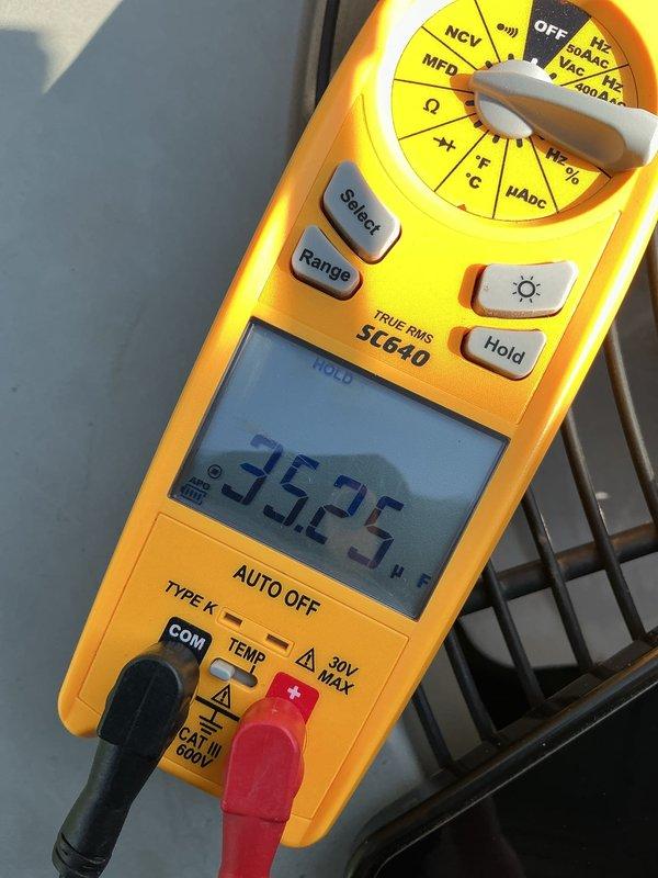 Responded to no cooling complaint on 10-year-old air conditioning system that had been blowing room temperature air since recent maintenance visit. Upon arrival, performed diagnostic testing of outdoor unit electrical components including capacitor and contactor within exterior control panel. Multimeter testing revealed capacitor failure with reading of 35.25 MFD, significantly below manufacturer specifications required for proper compressor operation. Electrical panel showed normal age-related accumulation of debris and environmental exposure but connections remained intact. Replaced failed capacitor, verified proper voltage and amperage readings across all electrical components, and confirmed contactor operation. Cycled system through complete operational test, verified proper compressor startup, and confirmed cold air delivery throughout home. System restored to normal cooling operation with appropriate temperature differential between supply and return air.